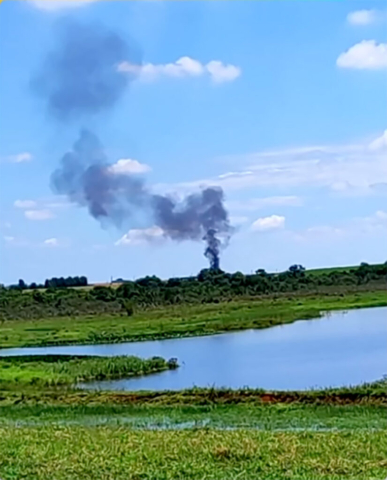 A small, high-wing Flight Design CT-U aircraft with a sleek composite fuselage and tricycle landing gear, resting in a field after impact. The scene is marked by scattered wreckage in a rural landscape, surrounded by sugarcane fields. The aircraft's lightweight structure and compact design highlight its role as a sport and recreational aviation model. Emergency responders are present, assessing the site for investigation. The sky is overcast, with no visible fire or smoke, suggesting the aircraft experienced control loss or mechanical failure before crashing.