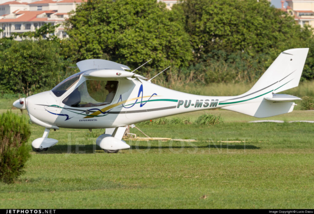 A small, high-wing Flight Design CT-U aircraft with a sleek composite fuselage and tricycle landing gear, resting in a field after impact. The scene is marked by scattered wreckage in a rural landscape, surrounded by sugarcane fields. The aircraft's lightweight structure and compact design highlight its role as a sport and recreational aviation model. Emergency responders are present, assessing the site for investigation. The sky is overcast, with no visible fire or smoke, suggesting the aircraft experienced control loss or mechanical failure before crashing.